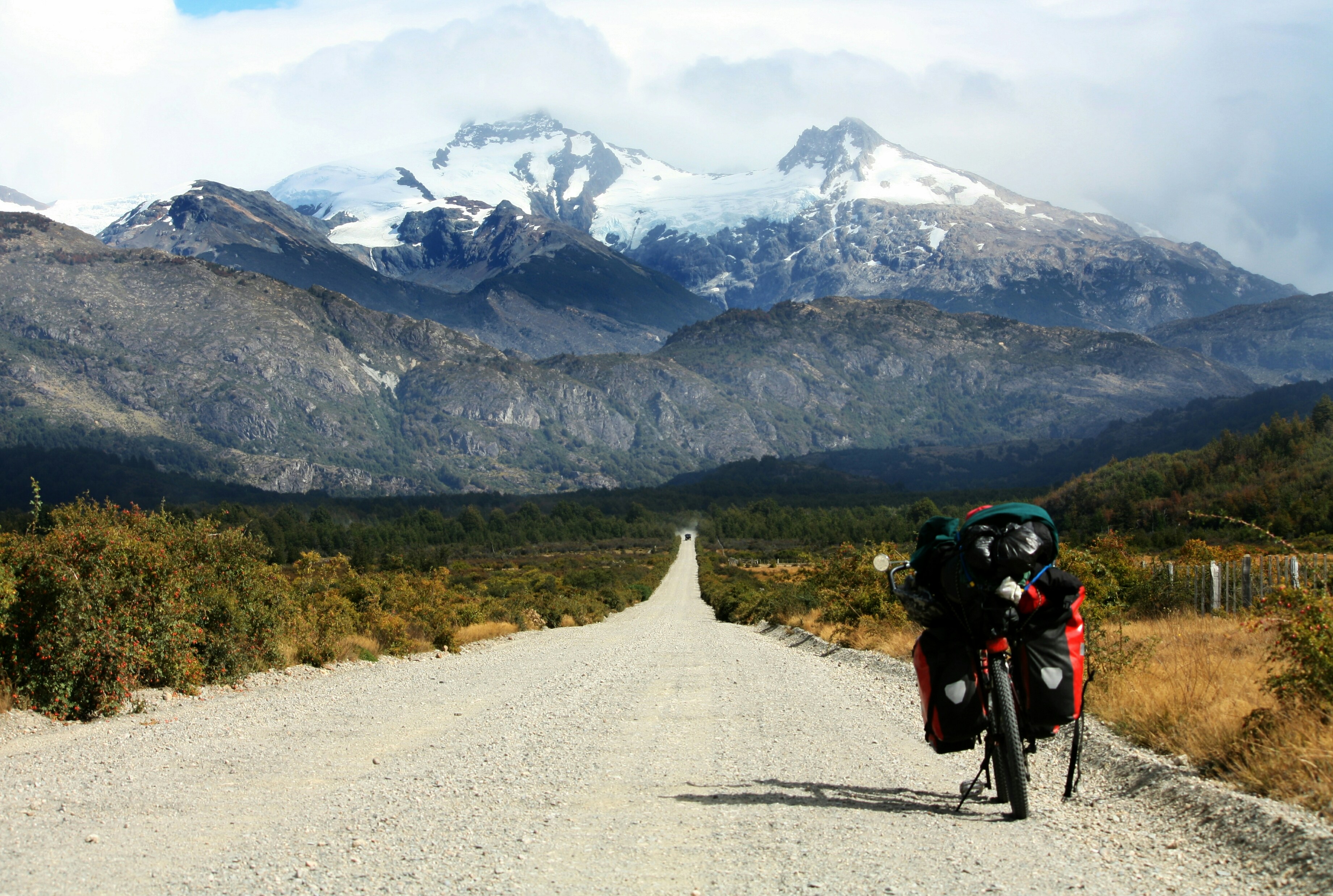 Black motorcycle parked on the road towards the glacier mountain